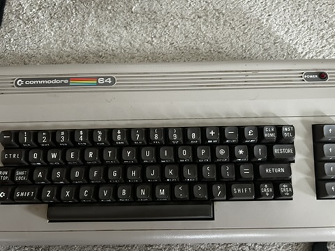 Commodore 64 keyboard close-up showing the distinctive chiclet keys and rainbow Commodore logo