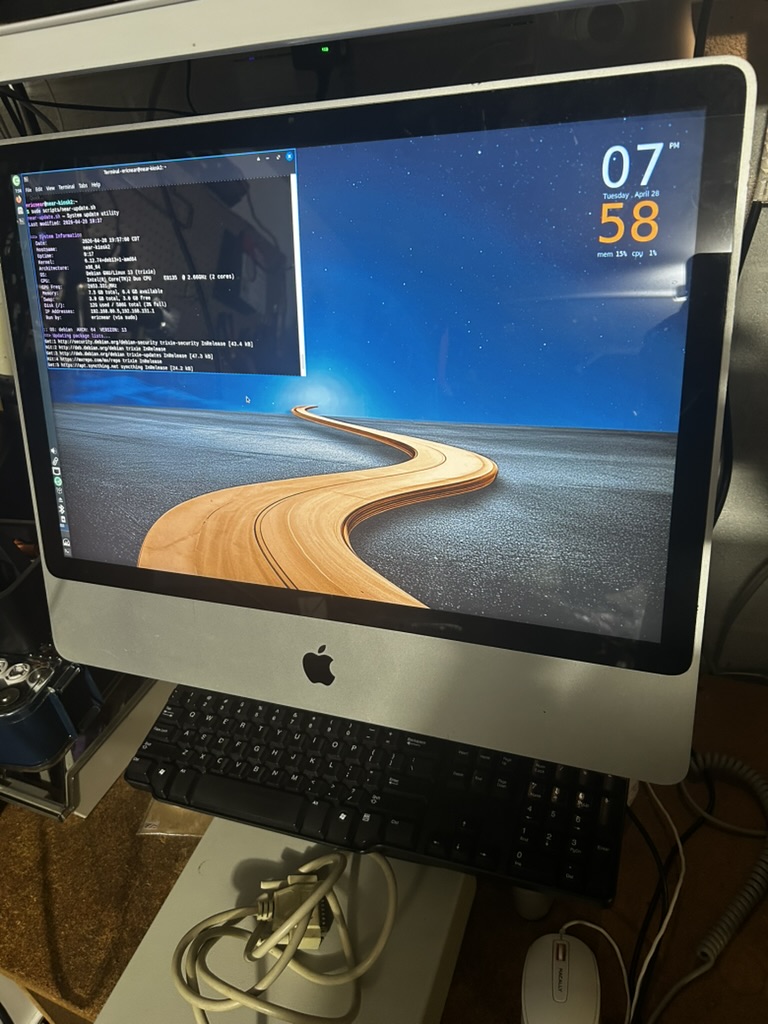 Apple iMac running Debian Linux with a terminal window open showing system information